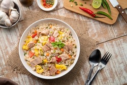 Tuna fried rice, Pan stir fry cooked rice with canned tuna fish ,tomato ,carrot ,peas and egg.Quick and Easy one dish meal on white plate