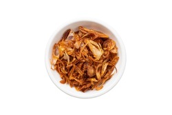 Crispy fried shallots on white bowl,staple condiment of Southeast Asian cuisine isolated on white background with clipping path