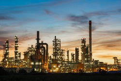Oil​ refinery​ and​  plant and tower column of Petrochemistry industry in oil​ and​ gas​ ​industrial with​ cloud​ orange​ ​sky the sunrise​ background​