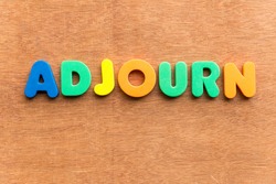 adjourn colorful word on the wooden background