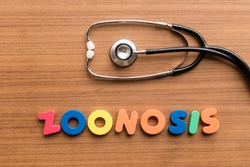 zoonosis colorful word on the wooden background with stethoscope