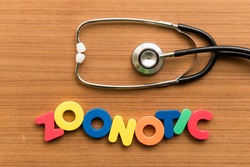 zoonotic colorful word with stethoscope on wooden background