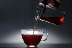 close-up of a hand taking a mug of tea, or coffee. pouring a cup, photographic technique darckfood