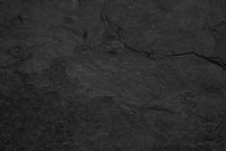 Dark grey black slate background or texture, stone wall surface.
