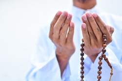 Muslim man in white session lift two hand for praying ,isolated on white background.concept for Ramadan, Eid al Fitr, eid ad-ha, meditation, islamic praying