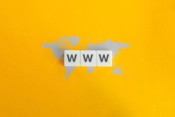 WWW (World Wide Web) on block letters. Grey world map on bright orange background. Minimal aesthetics.