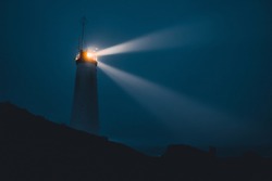 An Icelandic lighthouse in the moody dark night. Abstract image, dark mood. Iceland
