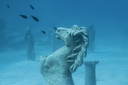 Sculptures and fishes underwater at Green Bay, Cyprus.