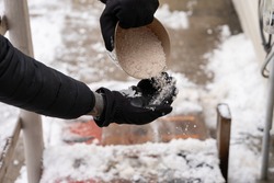 rock salt ice melt is being spread on your walkway to melt the ice and snow from your path