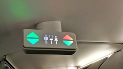 A lavatory sign on the ceiling of the commercial airlines. Selective focus.

