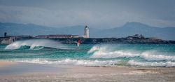 Panoramic view of Los Lances beach with Levante wind waves, and the lighthouse at the background, Tarifa, Cadiz province, Andalusia, Spain