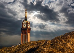 Beautiful view of Makkah Tower, Clock Tower under cloudy sky, top view and dry mountains of holy city of Makkah, Saudi Arabia