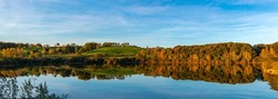 Panorama of a forest lake in autumn. Autumn panorama lakeview. Autumn lake reflection in autumn