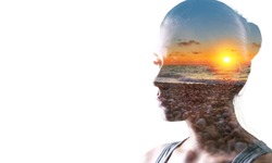 Psychoanalysis and meditation, concept. Profile of a young woman and sunset over the ocean, calm and mental health. Image with double exposure effect. The subconscious and how the brain works