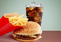 Tasty fresh burger, fries and coke on the wood table