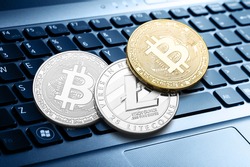 Many bitcoin coins on a laptop keyboard