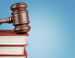 Judge gavel on law books in court, law and justice concept.