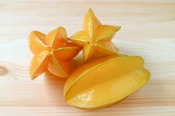 Heap of Fresh Ripe Carambola or Star Fruits Isolated on Wooden Background