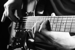 Music concept. Guitar acoustic. Play the guitar. Live music. Music festival. Instrument on stage, band. Electric guitar, guitarist, musician rock. Musical instrument. Guitars, strings. Black and white