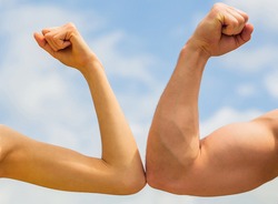 Sporty man and woman. Muscular arm vs weak hand. Vs, fight hard. Competition, strength comparison. Rivalry concept. Rivalry, vs, challenge, strength comparison.