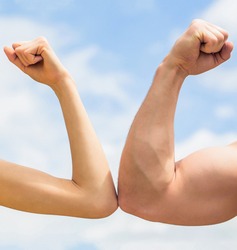 Vs, fight hard. Competition, strength comparison. Rivalry concept. Hand, man arm fist Close-up. Rivalry, vs, challenge, strength comparison. Sporty man and woman. Muscular arm vs weak hand.