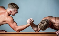 Two hands. Men measuring forces, arms. Hand wrestling, compete. Hands or arms of man. Arm wrestling. Two men arm wrestling. Rivalry, closeup of male arm wrestling.