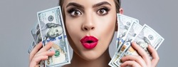 Woman holding lots of money in dollar currency. Luxury, beauty and money concept. Woman with dollars in hand. Portrait woman holding money banknotes. Girl holding cash money in dollar banknotes.