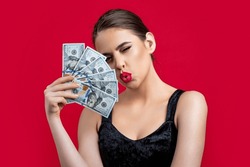 Woman with dollars in hand. Portrait woman holding money banknotes. Girl holding cash money in dollar banknotes. Woman holding lots of money in dollar currency. Luxury, beauty and money concept.