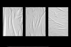 Three white crumpled sheets of paper on a black background.