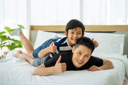 Asian business man father work from home and tacking care of son in new normal 