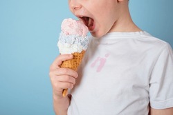Unrecognizable child eating ice cream. dirty stain of strawberry ice cream on white clothes. daily life stain and cleaning concept . High quality photo