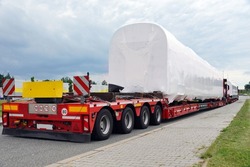 Oversize load or exceptional convoy. A truck with a special semi-trailer for transporting oversized loads. Very long vehicle. 