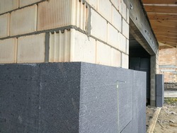 Thermal insulation with graphite polystyrene on the house wall at the construction site