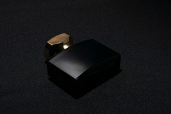 Perfume bottle. Mockup on dark or black empty background. Fragrance for man or woman. Top view. Horizontal photo with copy space