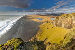 Aerial Panorama over Black Sand Beach, Mountains, and Ocean in Iceland