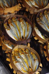 Tinapa fish galunggong bulilit dried smoked fish filipino food fresh uncooked for sale in the market 