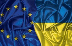 European union and Ukraine two folded silk flags together