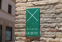 ruta de don quijote, green sign on a brick wall in toledo spain