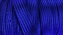 Blue fabric rope background. Roll of weave rope in the shop for sale.