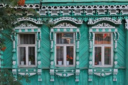 Decorated ornamental carved windows, frames on vintage wooden rural house in Suzdal town, Vladimir region, Russia. Russian traditional national folk style in wooden architecture. Countryside, village