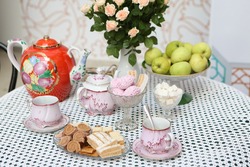 Russian Tea Party Ceremony with Kolomna pastille, delicious sweets. Table setting in russian style. Tradition of tea drinking in Russia. Vintage russian ware, retro pottery. Dulevo Porcelain teapot