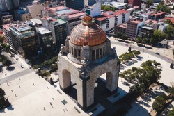Daytime aerial view of architectural landmark Monument to the Revolution located at Plaza de La Republica in Mexico City, Mexico.