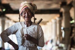 Old Burmese lady smoking a cigar and smiling in Indein village, Shan State, Myanmar (Burma).