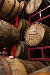 Wooden Bourbon barrels used to age mead, stacked on racks at a mead brewery in Baltimore.