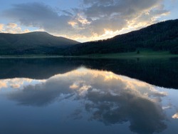 Pretty sunrise reflection of clouds over Pearl Lake near Steamboat Springs, Colorado