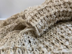 Hemp fibers woven into a piece, lightbrown natural fiber bundle texture and background