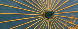 Image of a blue umbrella with yellow spokes that protects from the sun. 1930-1940 in Russia. Suitable as background, template, touristic guide, poster, greating card. Protection against sun concepts