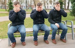 Handsome man like three wise monkeys. Japanese pictorial maxim, embodying the proverbial principle 