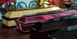 Coffins in a funeral home, burial, death of a loved one, high mortality.