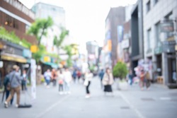 Abstract blurred asian crowd people, tourist group walking and shopping on street market daytime and light bokeh can be used for business background, Seoul, Korea, perspective view